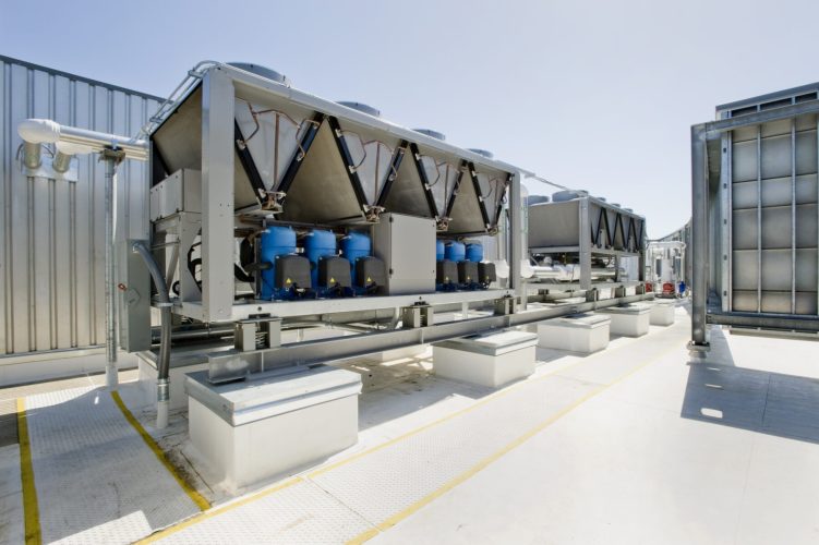 Rooftop cooling unit with chiller units and compressors.